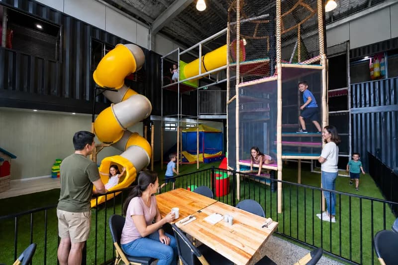 Kids on the double-storey Play Pen slide